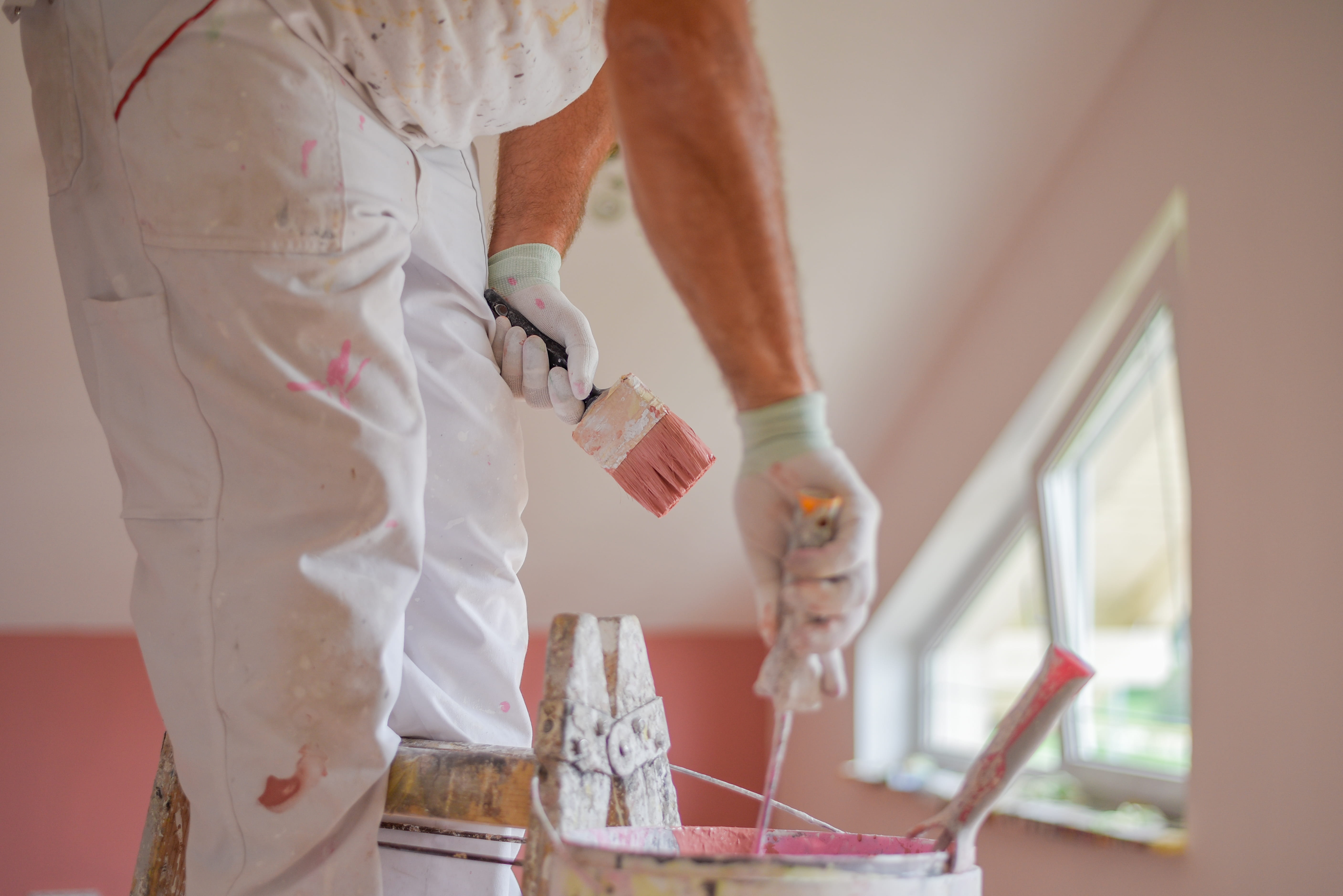 Residential painter applying fresh paint to a home interior